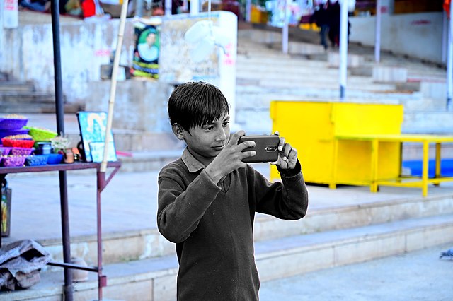 Child holding a camera.