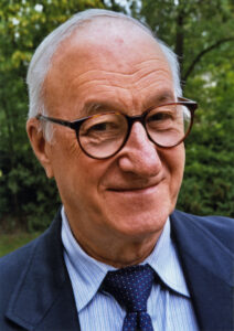 Older man with glasses smiling