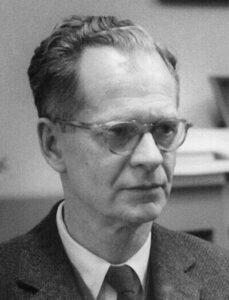 An older man in glasses wearing a suit and tie.