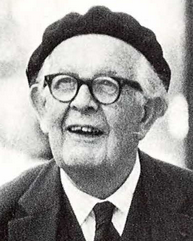 Black and white portrait of older man wearing glasses and grinning