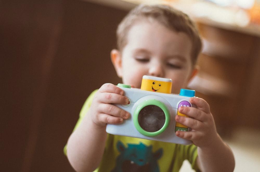 Public Domain Child holding a toy camera