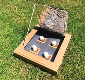 Box set up like an oven with ingredients to make s'mores