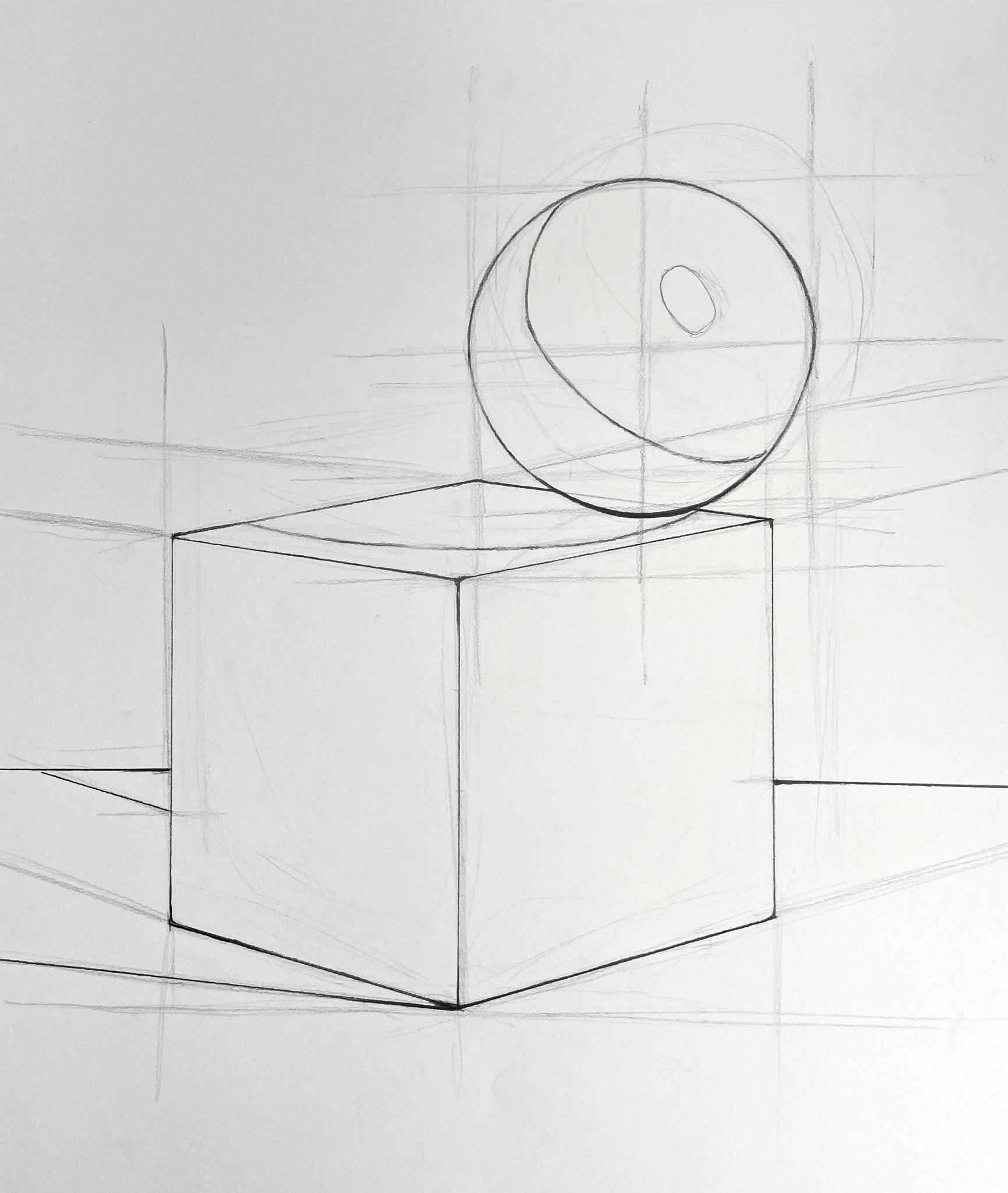 A pencil sketch showing a cube with a sphere resting on its top surface, drawn using perspective guidelines. The drawing highlights geometric shapes and spatial relationships with light construction lines and shading details.