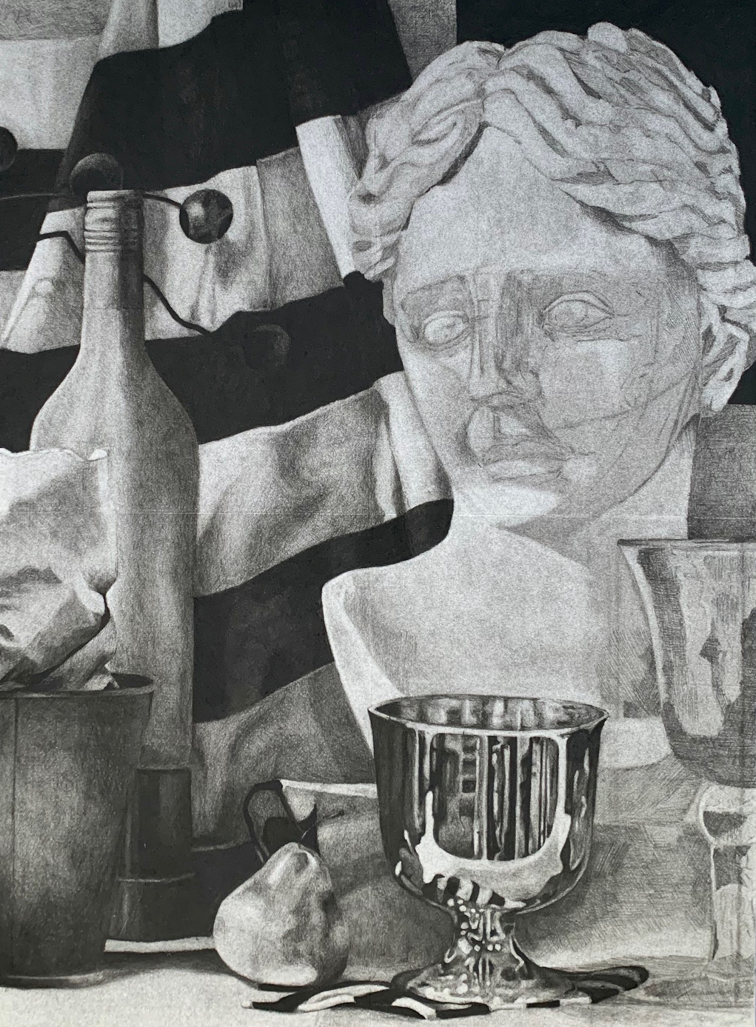 A black and white drawing of a still life arrangement featuring a classical bust, a reflective silver goblet, a pear, and various glass and metal vessels. The composition highlights contrasting textures and light reflections, with the bust positioned centrally and draped fabric in the background adding depth.