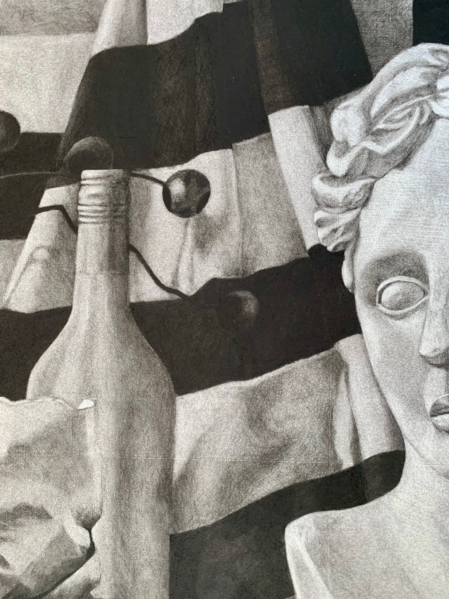 A black and white drawing featuring a classical-style bust sculpture on the right side, with detailed facial features and curly hair. The background includes a striped fabric with dark and light bands and a bottle with a hand holding it on the left side, creating a contrast between textures and shapes.