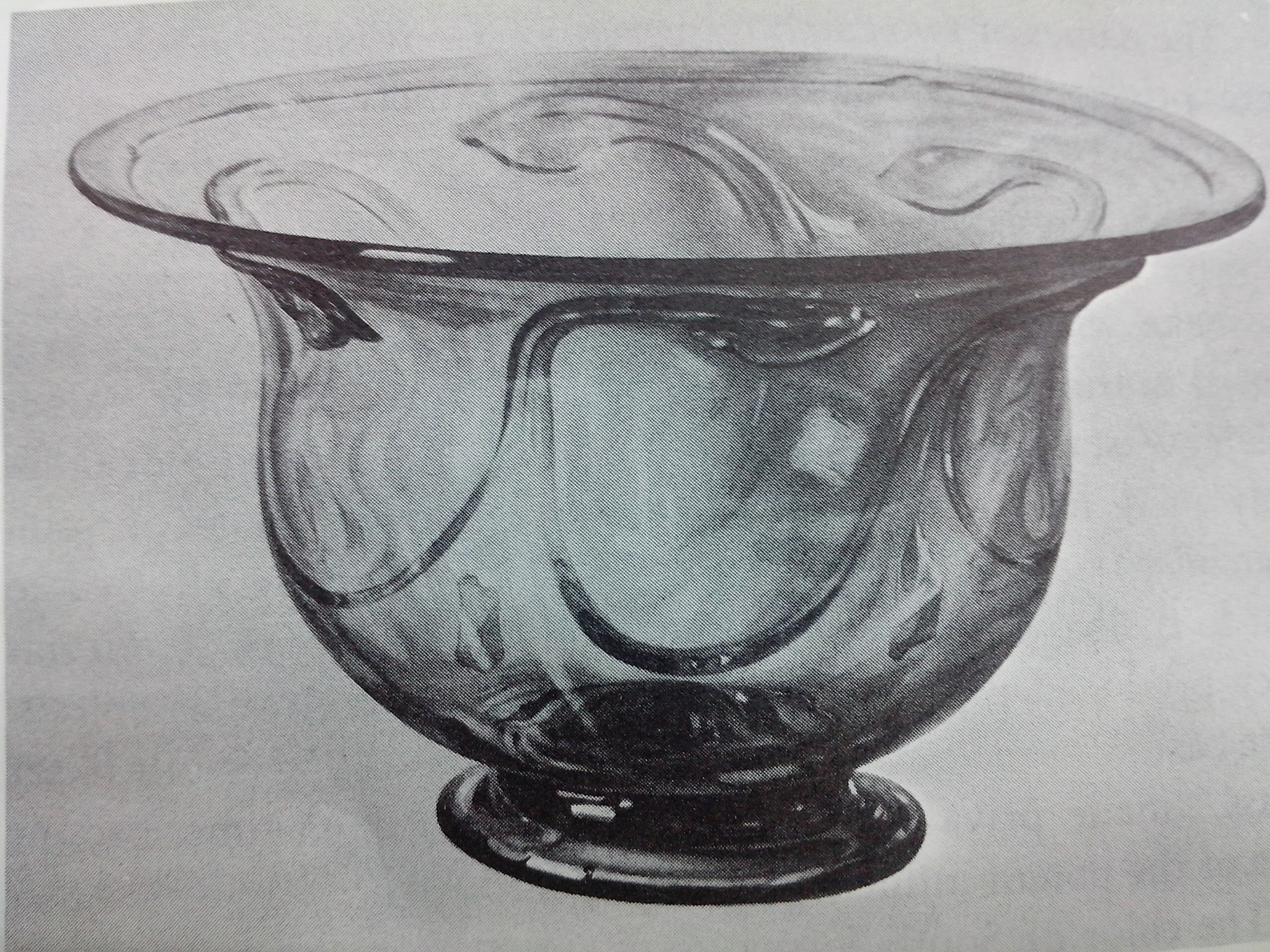 Drawing of a decorative glass bowl with a wide, flared rim and a rounded base. The bowl features an embossed swirling pattern throughout its translucent surface.