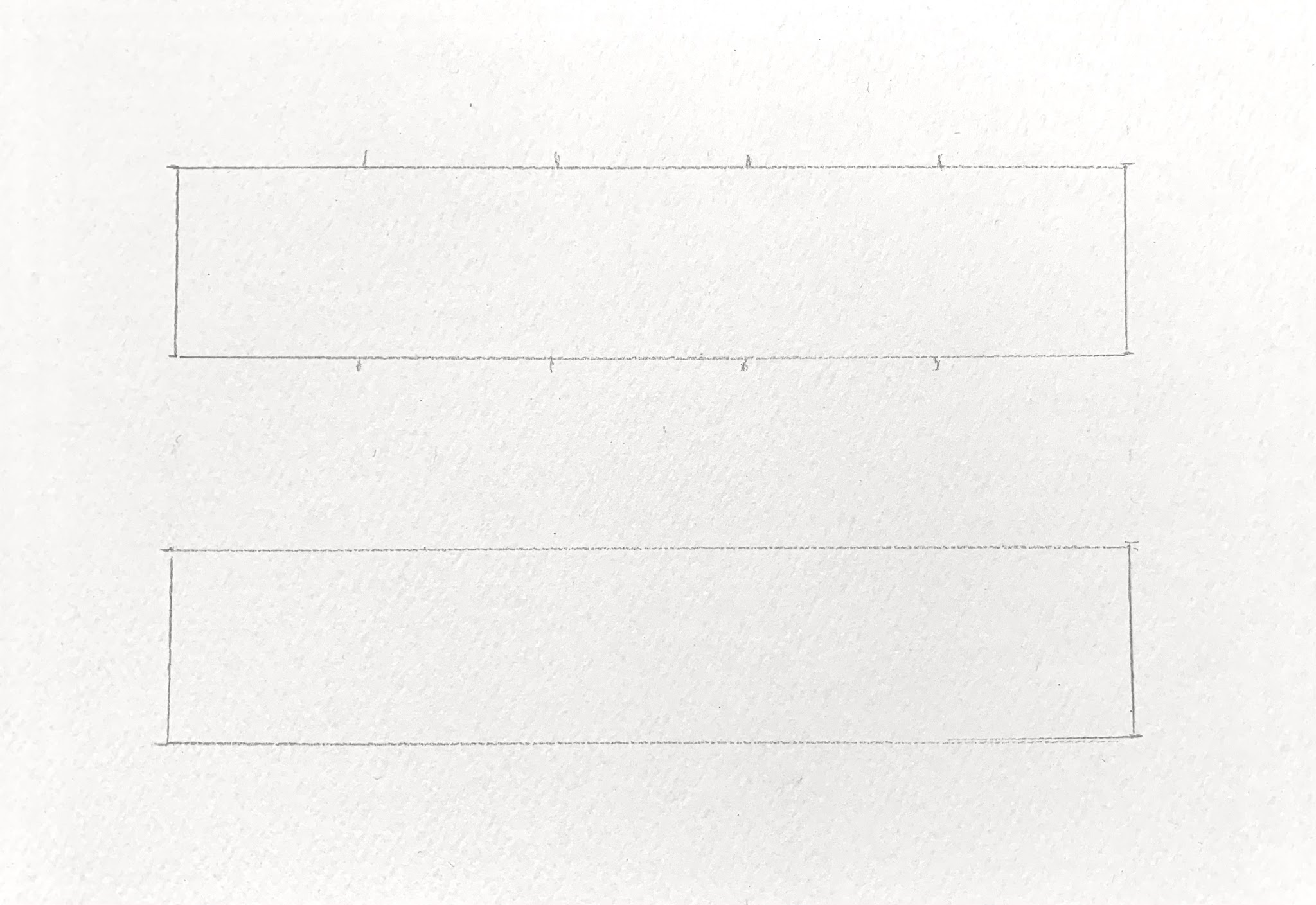 A photograph showing two rectangular boxes outlined with faint pencil lines on a white textured surface. Each rectangle has small tick marks evenly spaced along the top and bottom edges, suggesting a layout template.