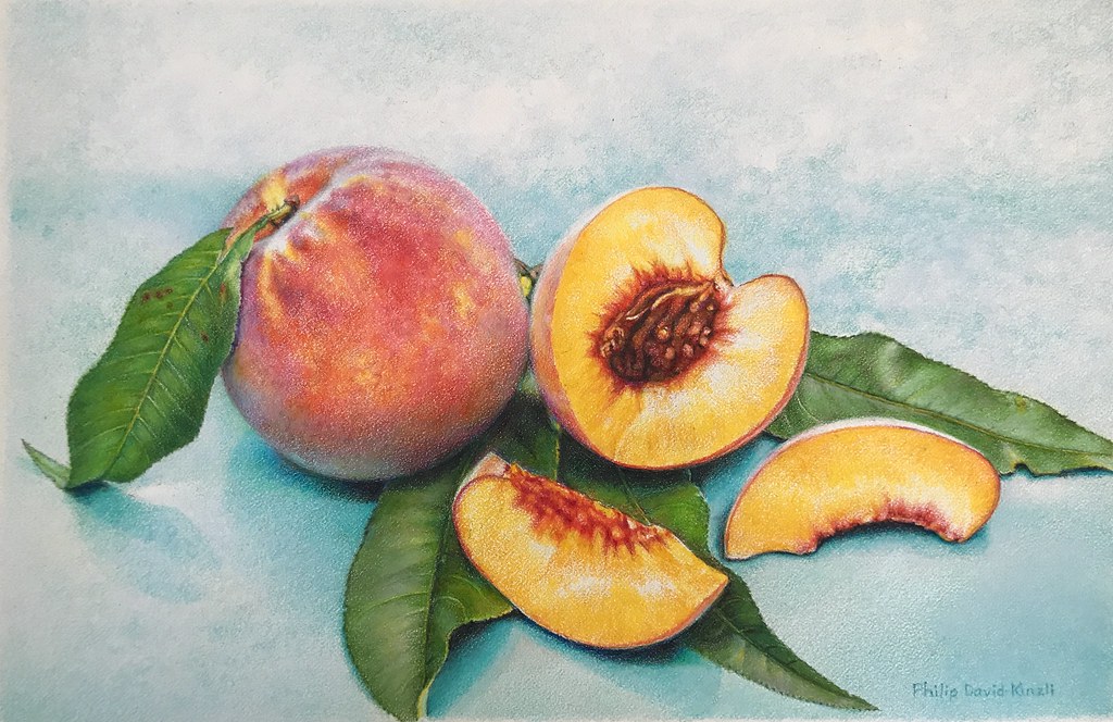 A photograph of a whole peach and three peach slices arranged on green leaves against a light blue background. The composition highlights the peach's fuzzy texture, vibrant orange-yellow flesh, and detailed pit in the central slice.