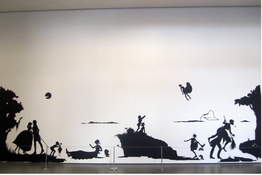 A black silhouette mural depicts various characters and scenes in a continuous horizontal sequence against a white background. Key elements include a person in a boat, two figures on a hallside, and groups of people interacting near trees, creating a narrative or story-like progression across the wall.