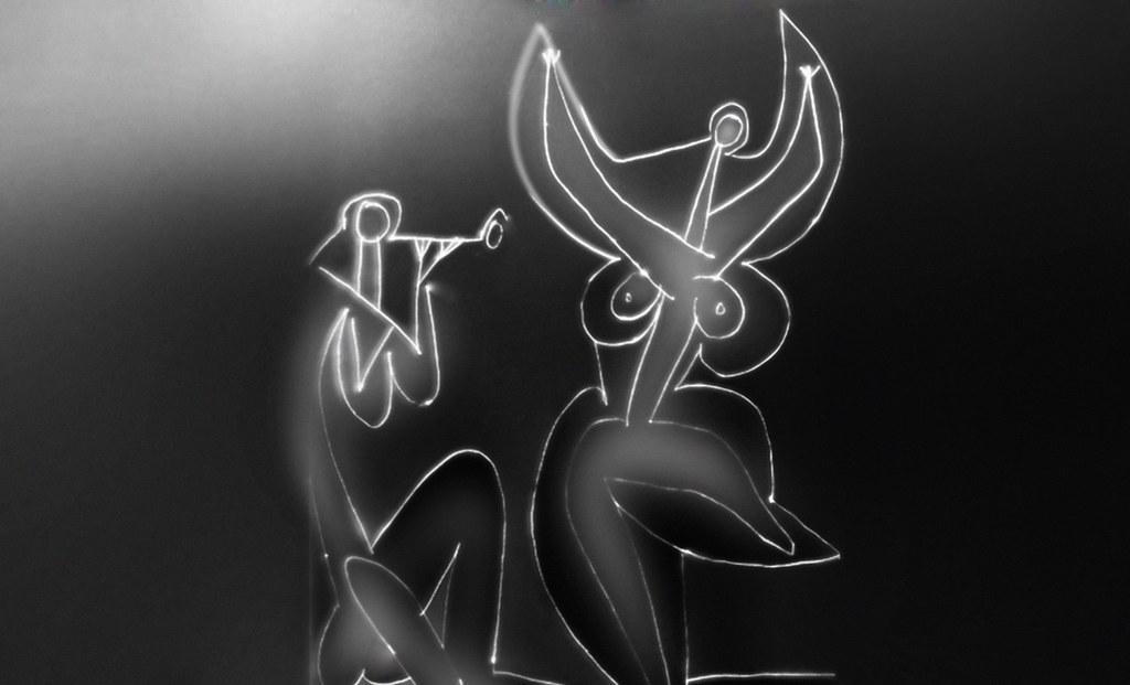 A black and white abstract drawing features two stylized figures with exaggerated, curved shapes and prominent eyes. The composition uses glowing white lines on a dark background, creating a surreal and expressive visual effect.