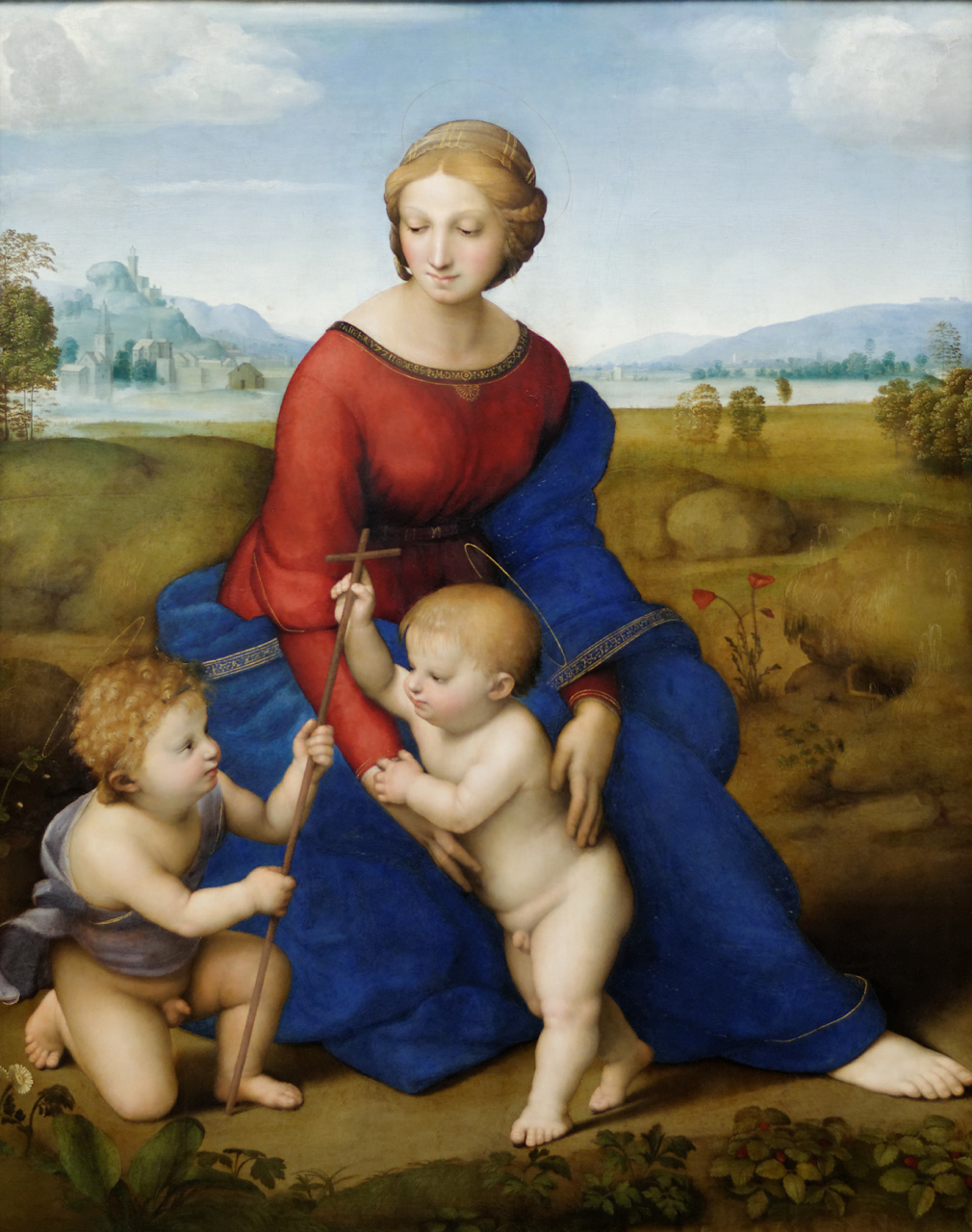 A Renaissance painting depicting a seated woman in a red and blue robe with two young children interacting beside her. The background features a serene landscape with distant mountains, trees, and a cloudy sky, highlighting themes of innocence and divinity.
