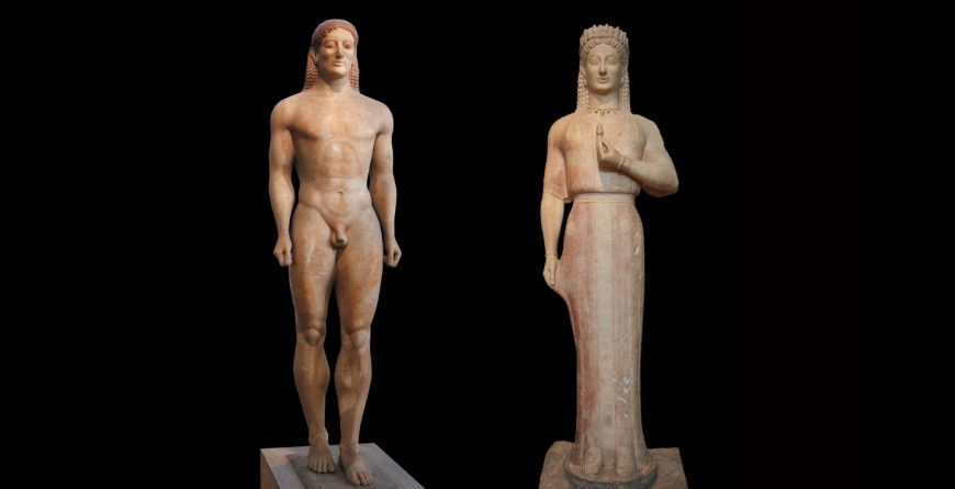 Two marble sculptures side by side with a black background. On the left is a life-size nude male sculpture with one leg coming forward while on the right is a clothed female sculpture with one arm at her side and the other in front of her chest.