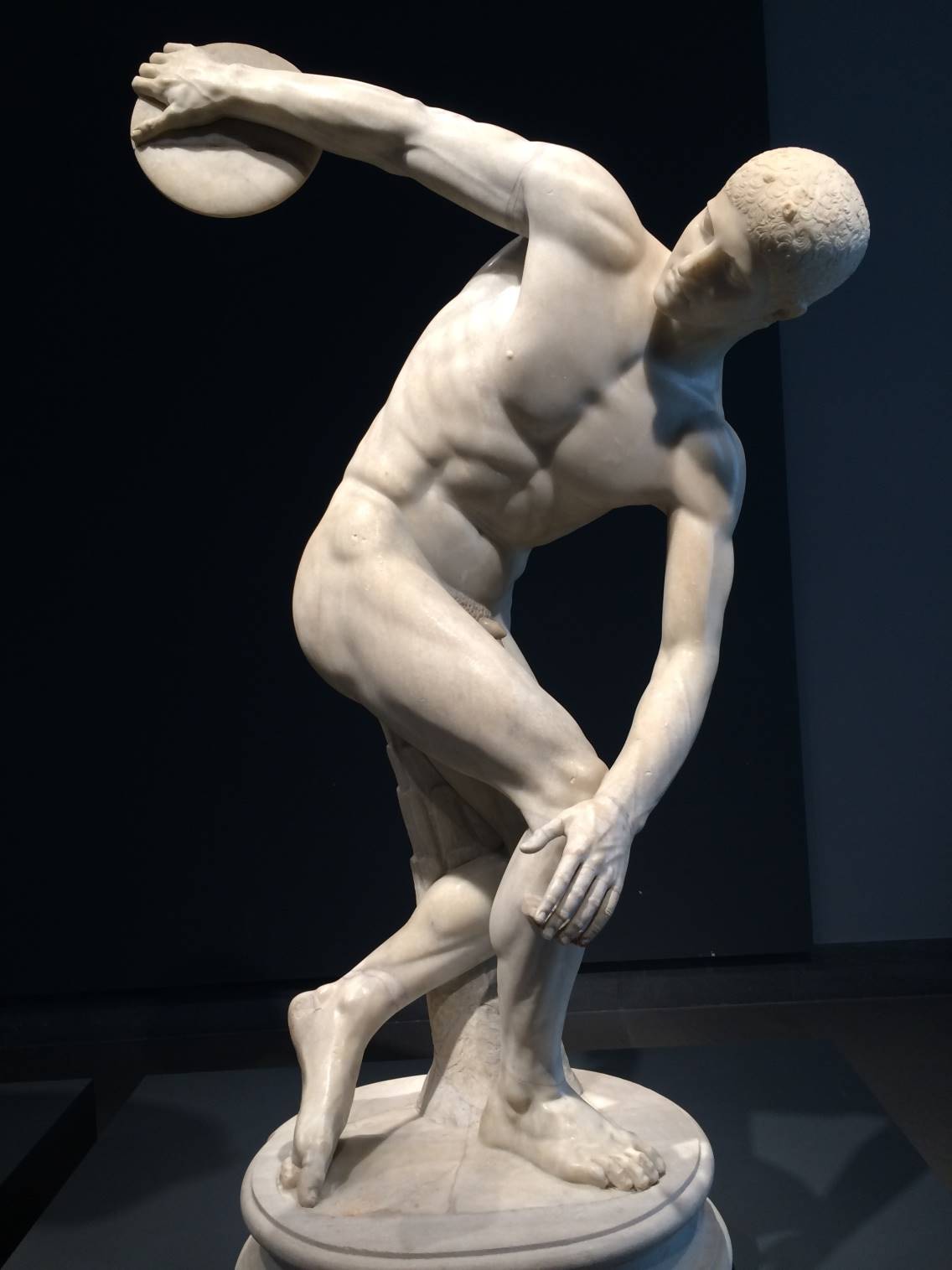 Nude male sculpture showing in the act of throwing a discuss