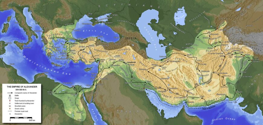 Map illustrating the empire of Alexander the Great from 336 to 323 BCE, highlighting key cities, routes taken by Alexander, and battle sites. The map uses color gradients to show terrain elevation and includes labeled regions across Europe, Asia, and Africa, emphasizing the vast extent of Alexander's conquests.