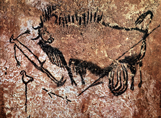 Photograph of prehistoric cave painting depicting a hunting scene with a human figure and a disemboweled bison. Artwork features black pigment on a textured brown rock surface with additional markings and a bird-like figure near the hunter.