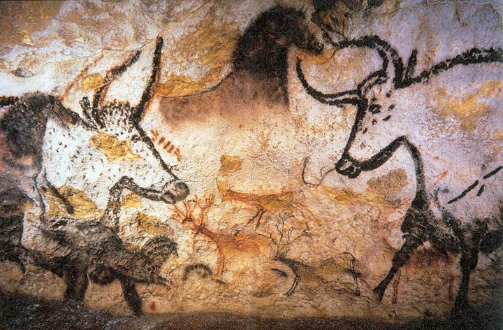 Photograph of prehistoric cave paintings depicting various animals, including large bulls and smaller creatures, rendered in black, brown, and ochre pigments. The artwork showcases detailed outlines and shading, illustrating early human artistic expression and wildlife observation.