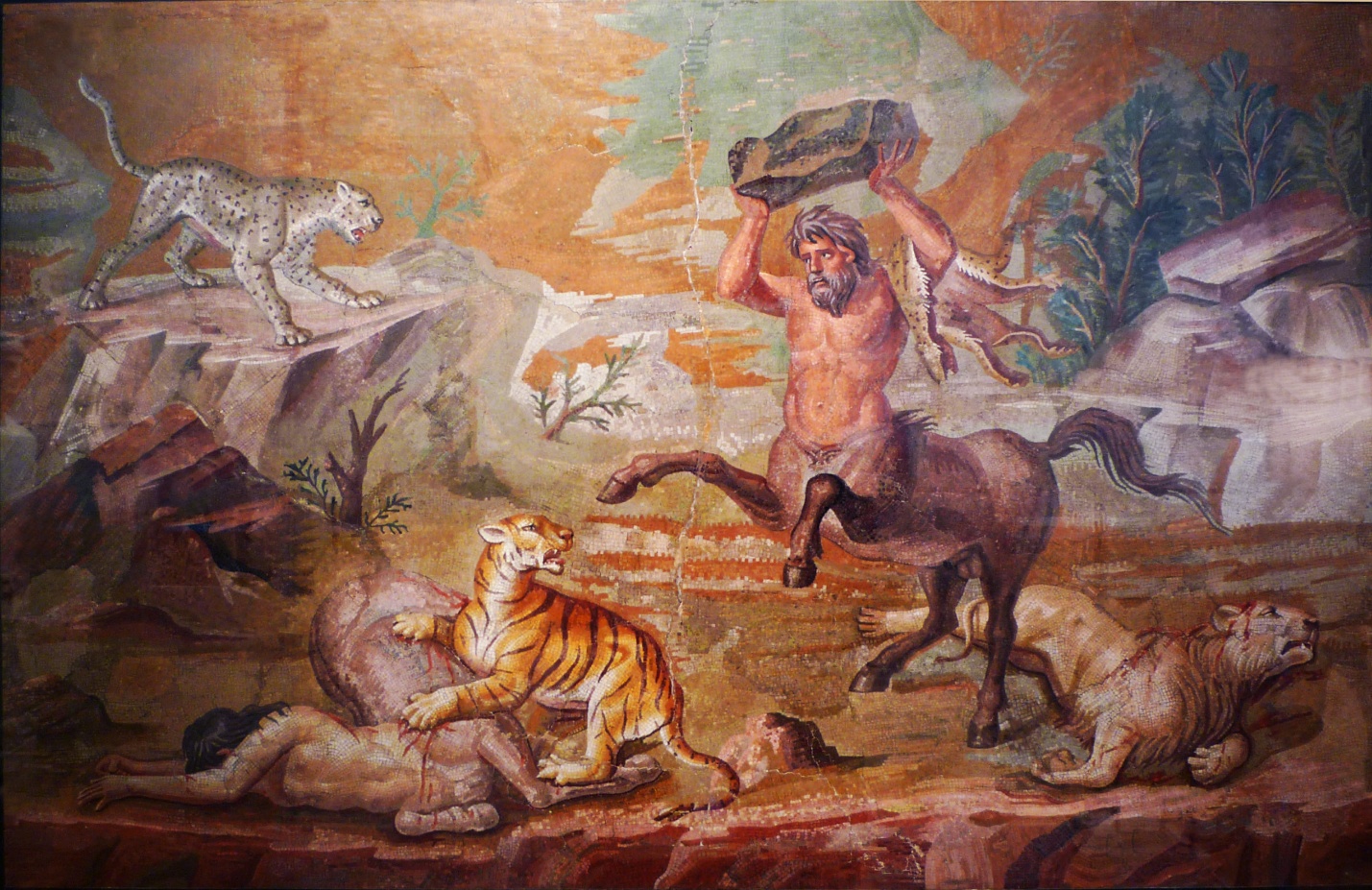 Pair of Centaurs Fighting Cats of Prey from Hadrian's Villa, mosaic featuring a centaur of half man and half horse fighting a tiger and a leopard. The scene is set in a natural landscape with rocks and trees and painted in tones of orange, brown, and green.