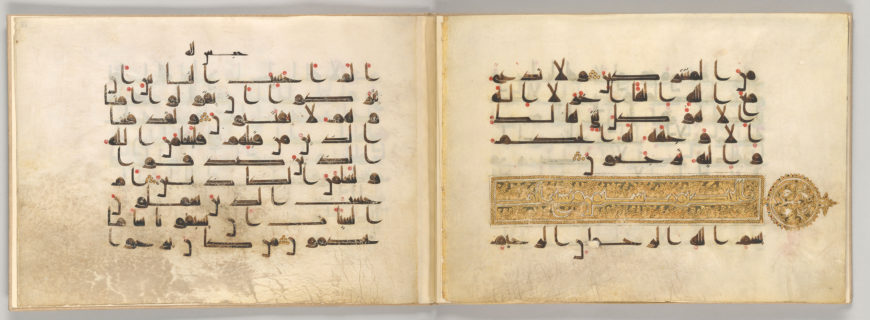 Two-page spread of an ancient manuscript featuring Arabic calligraphy in black ink with red diacritical marks. The right page includes an ornate gold decorative band and circular emblem, indicating a significant section or chapter marker.