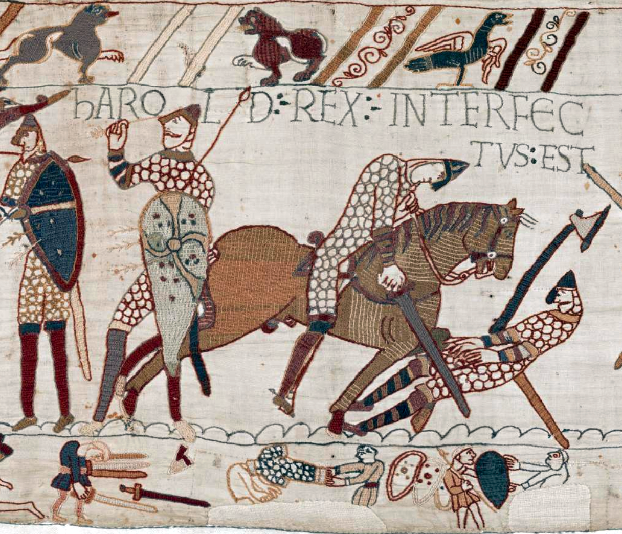 Tapestry panel depicting a medieval battle scene with armored knights, one on horseback, engaged in combat. Text in Latin above figures identifies a key event, with detailed patterns on shields, weapons, and clothing highlighting historical warfare.