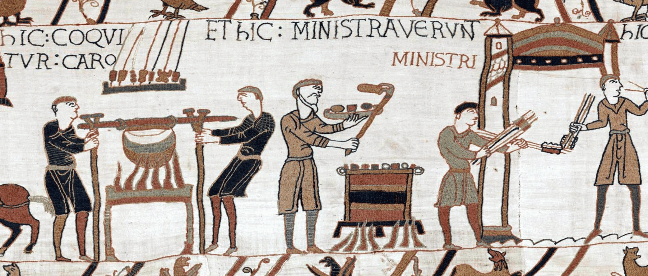A medieval tapestry scene depicting several figures engaged in preparing food. The artwork features Latin inscriptions above the characters and is rendered in muted earth tones with detailed line work characteristic of historical embroidery.