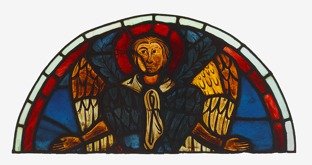 Stained glass window depicting an angel with outstretched arms, featuring vibrant colors including red, blue, yellow, and orange. The semi-circular design includes a red halo around the angel's head and detailed wings with intricate patterns.