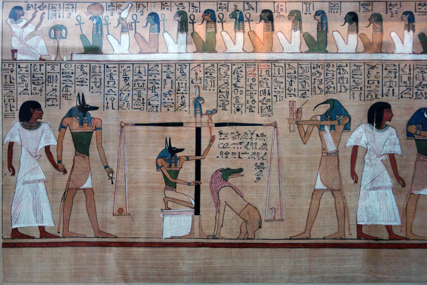 Ancient Egyptian papyrus painting depicting a scene from the Book of the Dead, illustrating the weighing of the heart ceremony. Key elements include Anubis overseeing scales balancing a heart against a feather, a seated figure recording results, and hieroglyphic text above and below the scene.