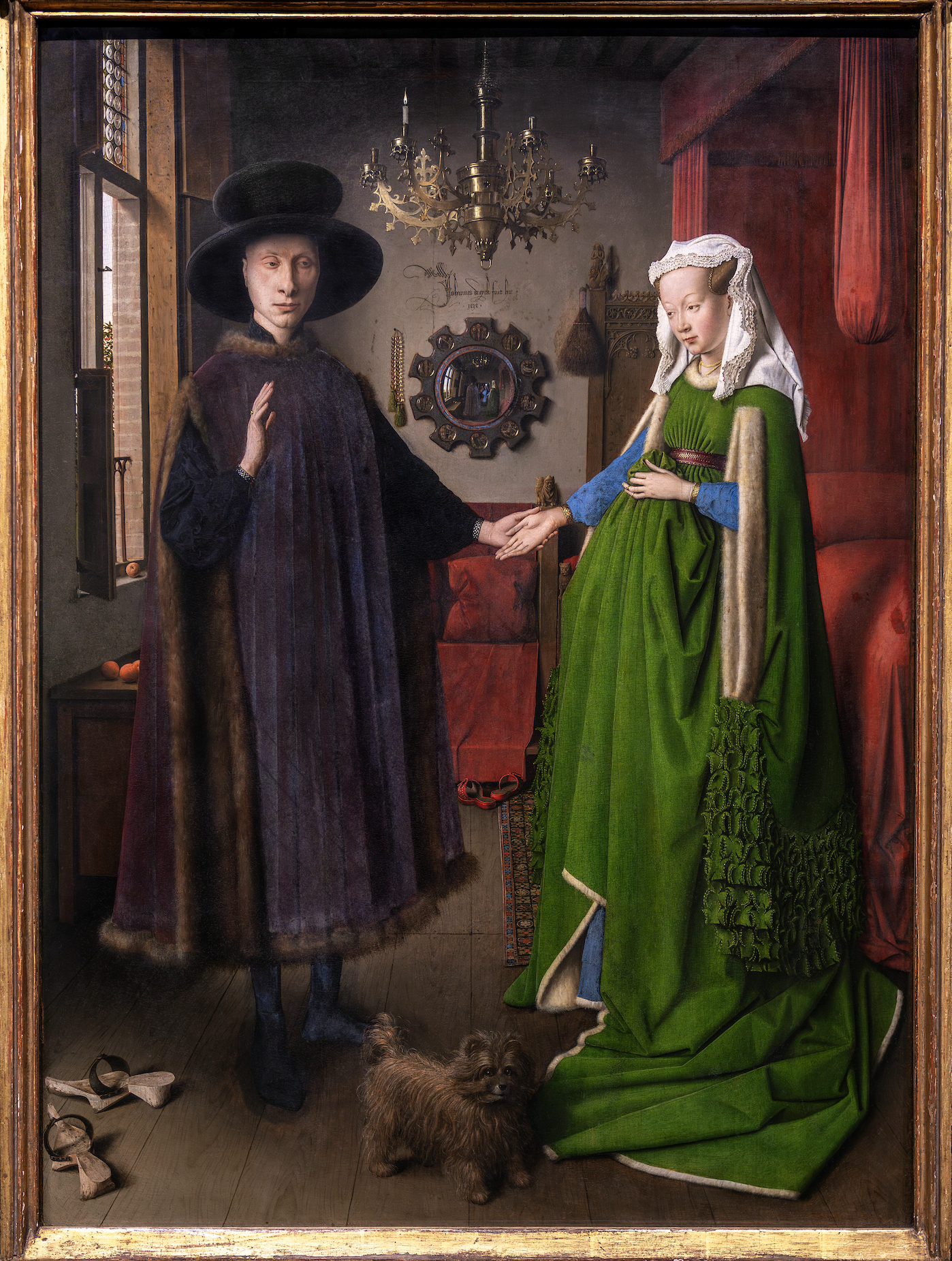 Jan van Eyck, The Arnolfini Portrait painting depicting a man and a woman holding hands in an interior room, with a small dog at their feet. The scene features detailed clothing, a chandelier, a mirror on the wall, and shoes on the floor, highlighting a moment of domestic life and connection.
