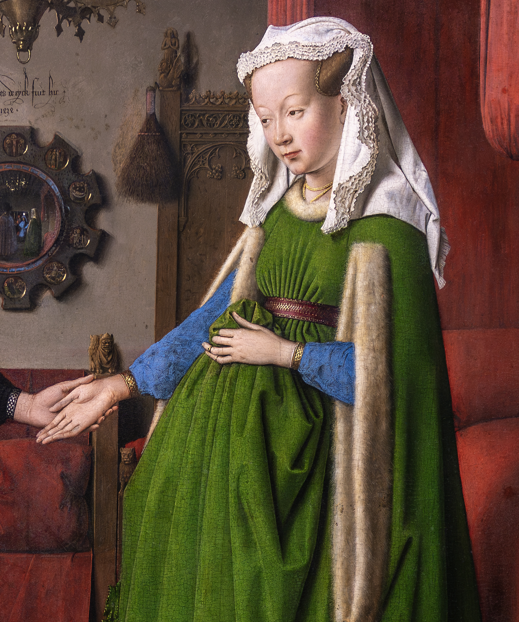 Dress (detail), Jan van Eyck, The Arnolfini Portrait depicting a woman in a green dress with blue sleeves and a fur-lined cloak, wearing a white headdress, holding her fabric with one hand and another person's hand with the other. The background includes a red curtain, ornate wooden furniture, and a circular mirror reflecting two figures.