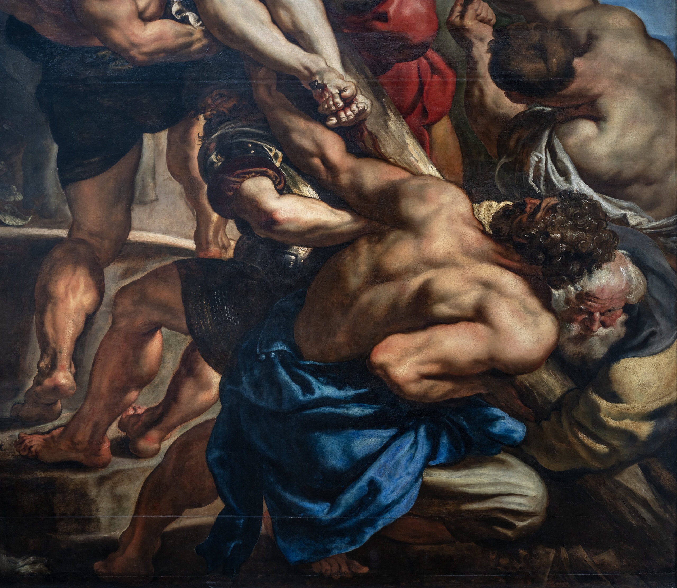 Figures raising from the cross (detail), Peter Paul Rubens, Elevation of the Cross painting depicting a group of muscular men struggling to carry a large wooden cross, emphasizing physical strain and emotional intensity. Rich use of chiaroscuro highlights detailed anatomy, dynamic poses, and dramatic tension among figures dressed in classical garments.