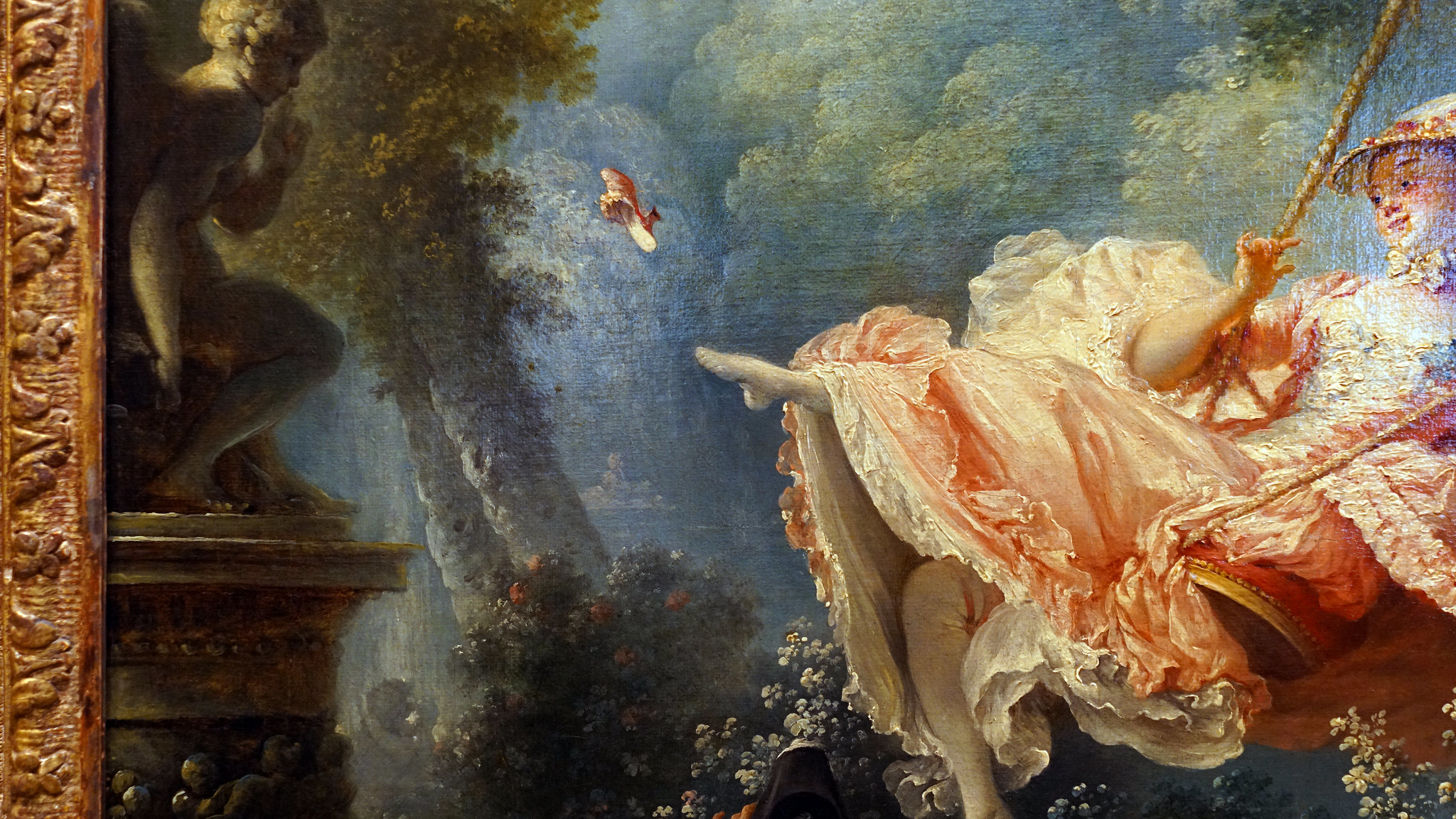 Female figure (detail), Jean-Honoré Fragonard, The Swing, depicting a woman in an elaborate pink dress swinging joyfully on a swing in a lush garden. The scene includes detailed foliage, a cherub statue on the left, and the woman's shoe delicately flung and in mid-air.