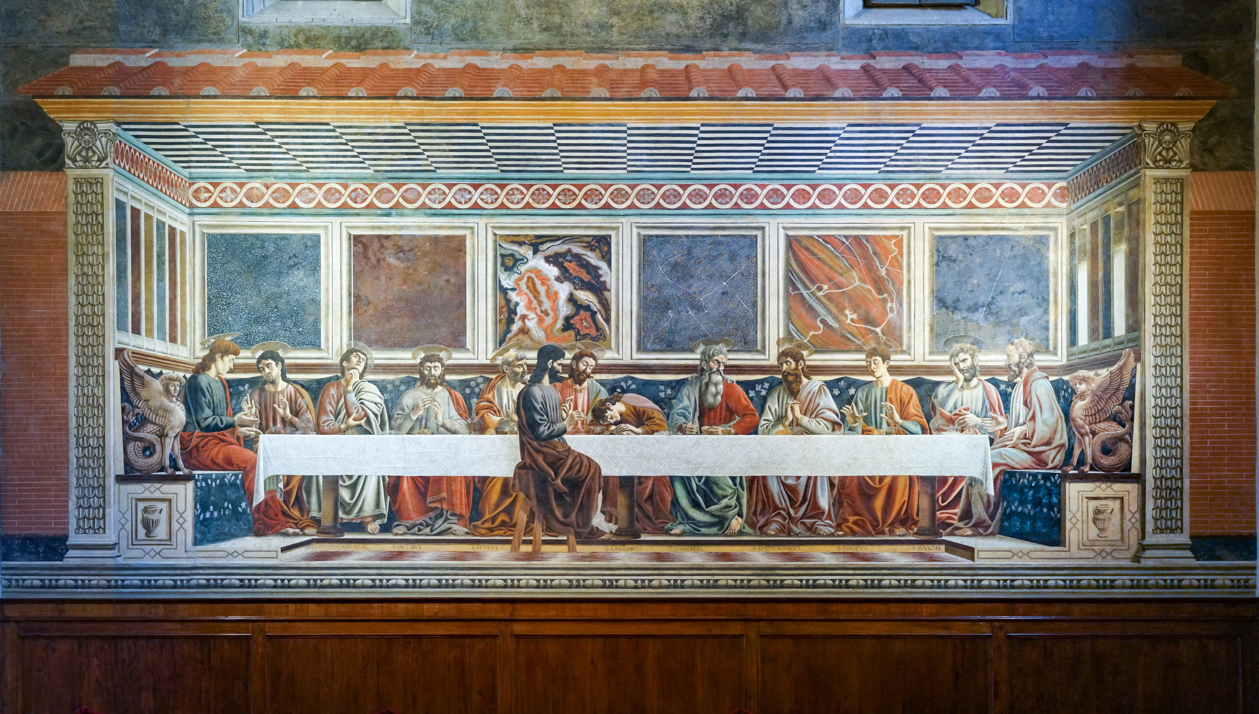 Andrea del Castagno, The Last Supper, 1447, a large Renaissance fresco depicting the Last Supper with Jesus and twelve apostles seated at a long table. The fresco features detailed architectural elements, vibrant colors, and expressive figures, highlighting key moments of the biblical scene.