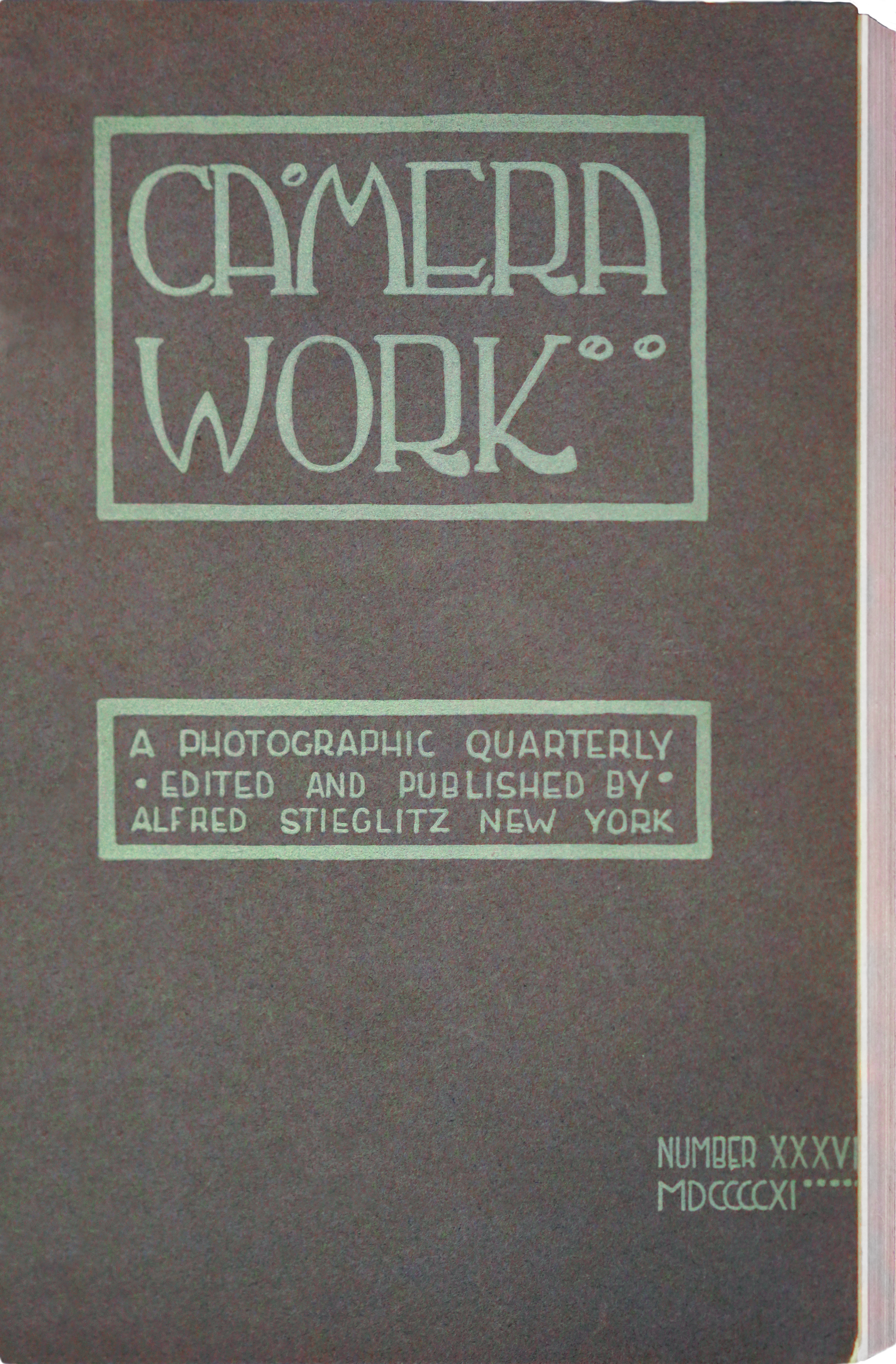 Cover page of a vintage photographic quarterly titled "Camera Work," edited and published by Alfred Stieglitz in New York. The design features stylized green text on a dark background, with issue number XXXVI and year MDCCCCXI (1911) indicated.