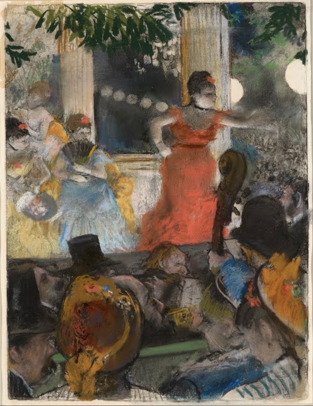 Degas, Café-Concert at Les Ambassadeurs pastel drawing depicting a lively indoor social scene with a woman in a red dress dancing on a stage or platform, surrounded by seated and standing spectators wearing hats and formal attire. The artwork features soft, blended colors with emphasis on figures and movement, capturing the atmosphere of a late 19th-century cabaret or theater setting.