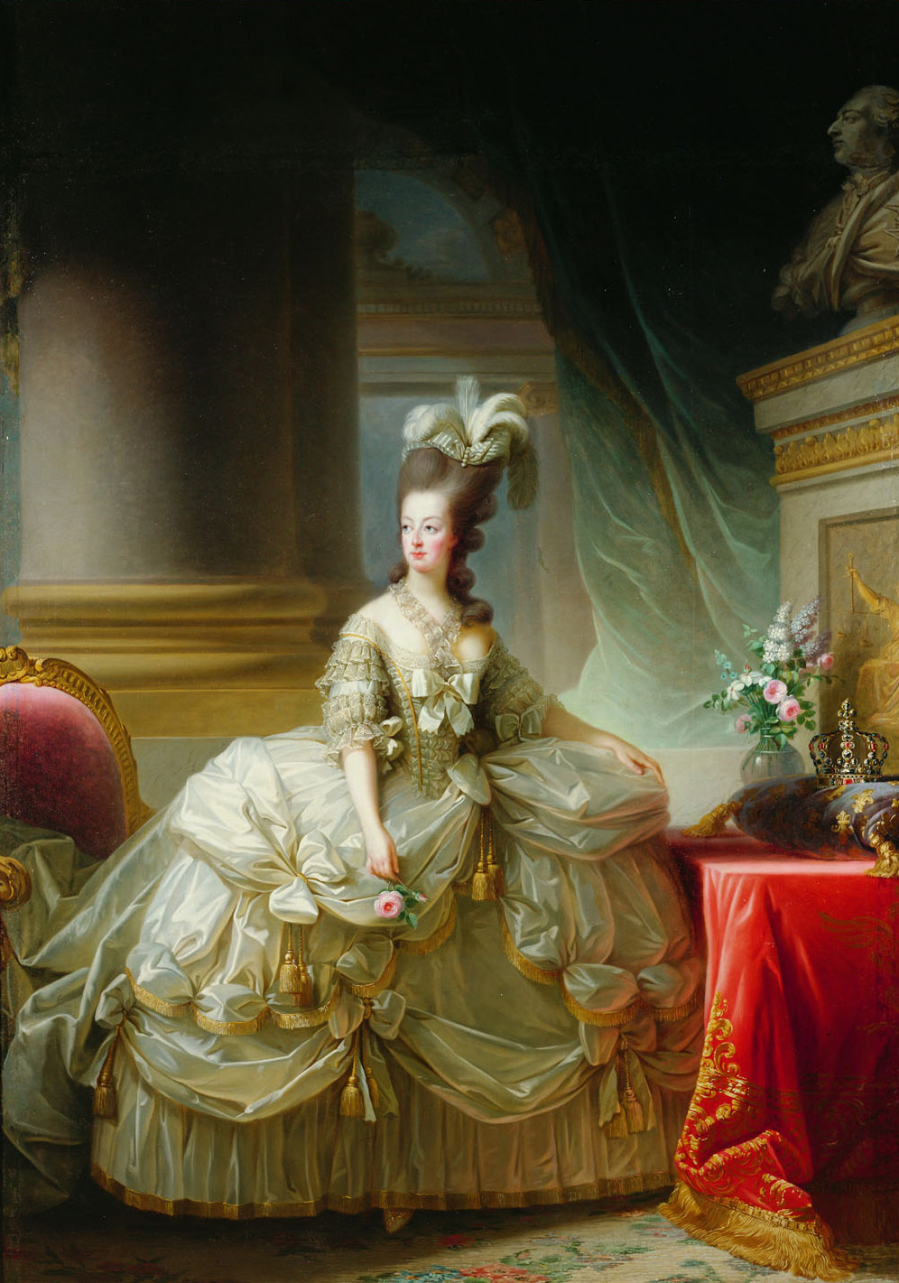 Élisabeth Louise Vigée Le Brun, Archduchess Marie Antoinette painting portrait of a woman in an elaborate 18th-century gown with intricate ruffles and bows, standing beside a red-draped table adorned with a crown and floral arrangement. The background features grand architectural elements, including a large column and a statue bust.