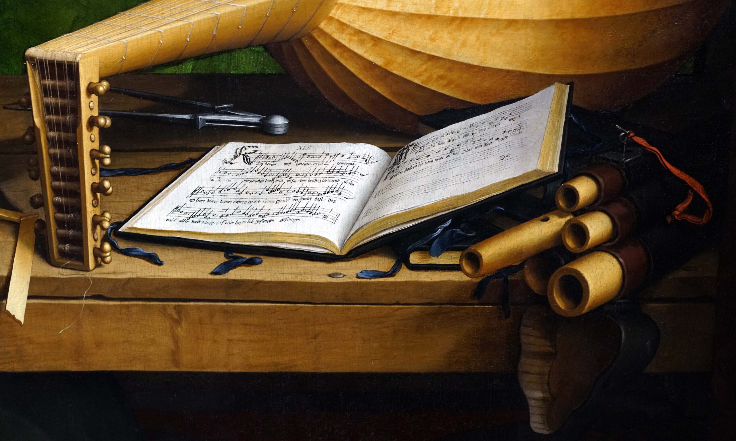 Luther's Hymn Book (detail), Hans Holbein the Younger, The Ambassadors featuring a lute, an open music book with handwritten sheet music, and a set of wooden recorders resting on a wooden surface. The composition highlights textures of wood and paper, with warm lighting emphasizing details like the lute's strings and the musical notes on the open book.