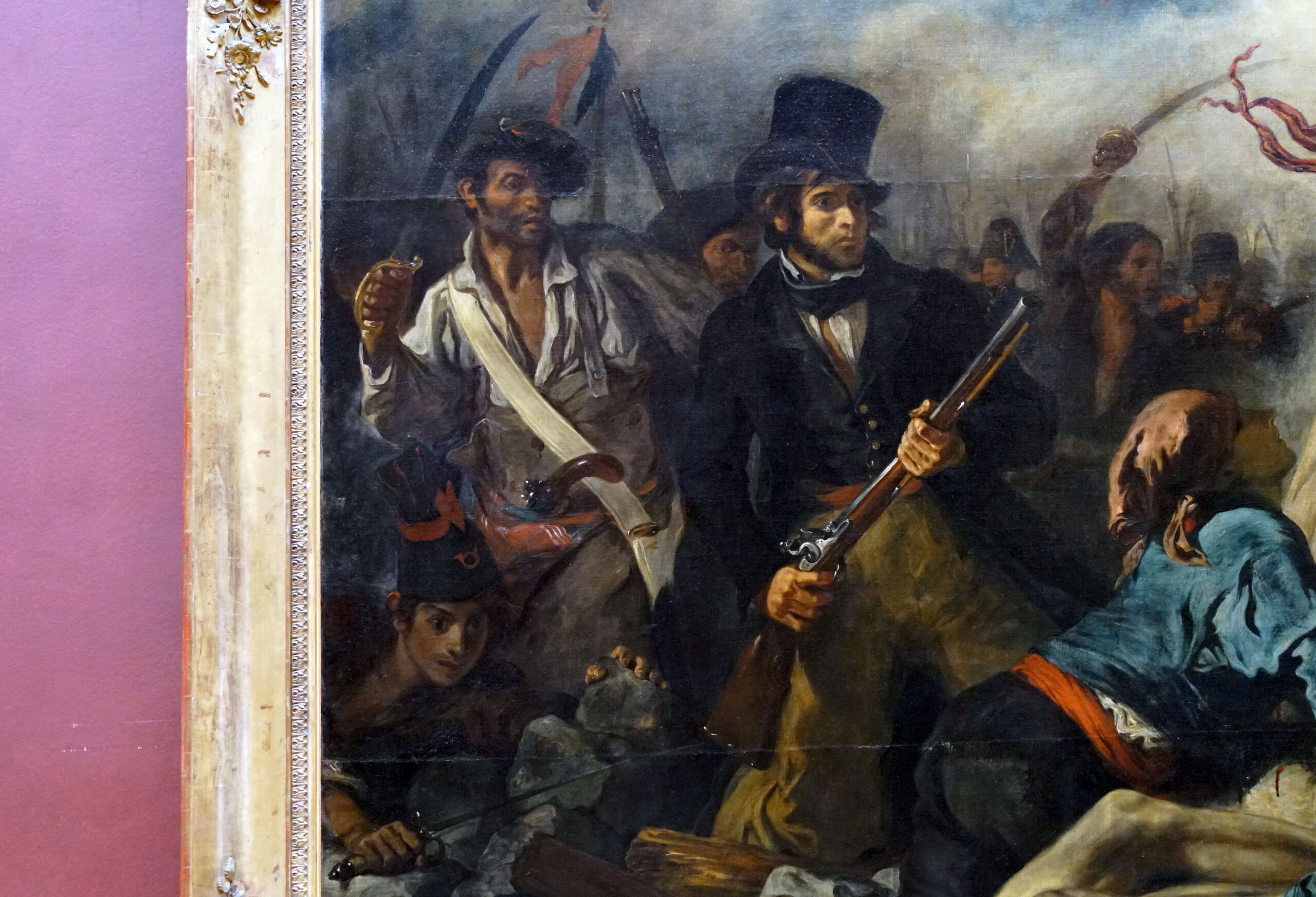 A photograph of a Figures at left (detail), Eugène Delacroix, Liberty Leading the People (July 28, 1830), depicting a chaotic battle scene with armed men in 19th-century attire. The painting features dark, dramatic colors, detailed expressions, and dynamic poses, emphasizing tension and movement during conflict.