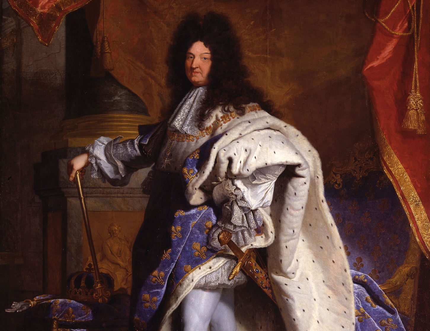 The king (detail), Hyacinthe Rigaud, Louis XIV, depicting a royal figure dressed in elaborate blue and gold fleur-de-lis patterned robes with a white fur-lined cape, holding a scepter and standing beside a crown. Rich red drapery and ornate architectural elements frame the figure, emphasizing regal authority and grandeur.