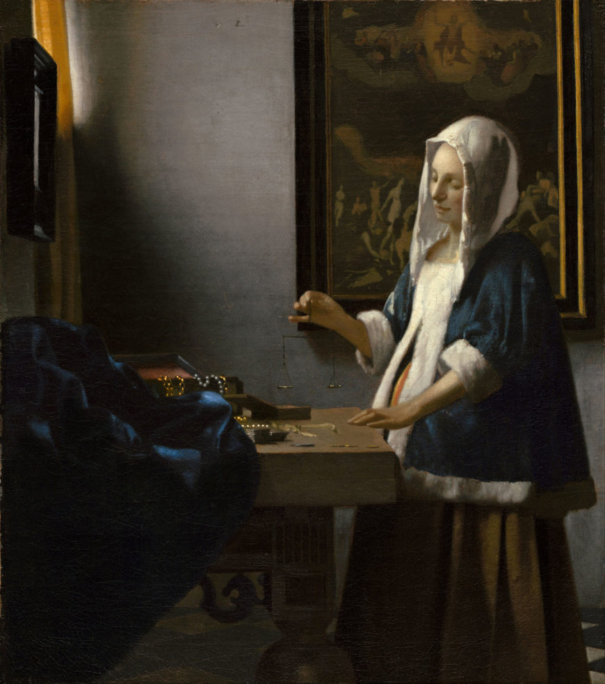 Johannes Vermeer, Woman Holding a Balance painting depicting a woman dressed in 17th-century attire standing by a table with coins and jewelry, illuminated by soft natural light from a window. The scene includes a dark blue draped cloth on the table, a large framed painting on the wall behind her, and a checkered floor.