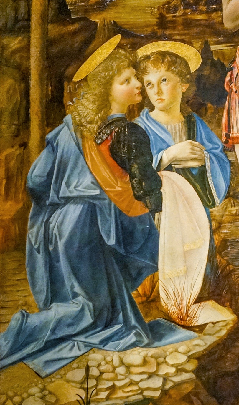 Detail, Andrea del Verrocchio (with Leonardo), Baptism of Christ depicting two haloed figures kneeling on a stone surface, dressed in flowing blue and red robes. The scene includes detailed textures of fabric and stone, with warm earth tones in the background and a white cloth held by one figure, suggesting a biblical or saintly context.