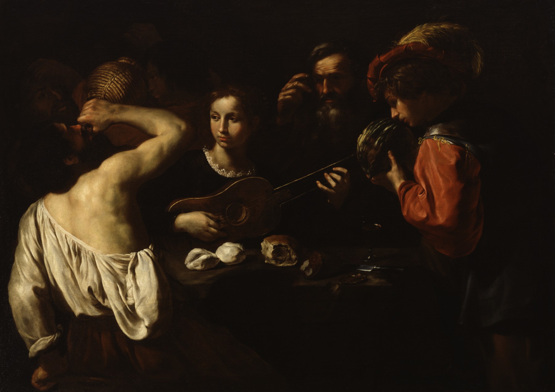 Pietro Paolini, Allegory of the Five Senses painting depicting a group of people gathered around a table, with one person playing a guitar and another drinking from a vessel. The composition uses strong chiaroscuro contrasts, highlighting figures' faces and hands while much of the background remains in shadow, emphasizing a lively, intimate scene.