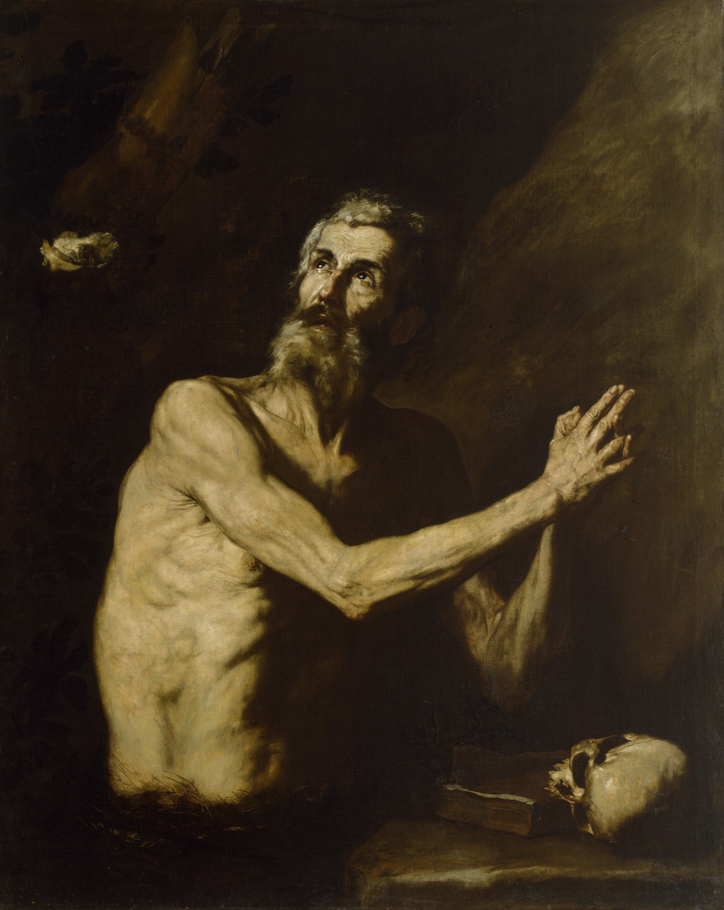 Jusepe de Ribera, St Paul the Hermit painting depicting an emaciated, shirtless man with hands clasped in prayer, illuminated by a beam of light from the upper right. The dark background contrasts with the man's pale skin, and a skull rests on a table beside him.