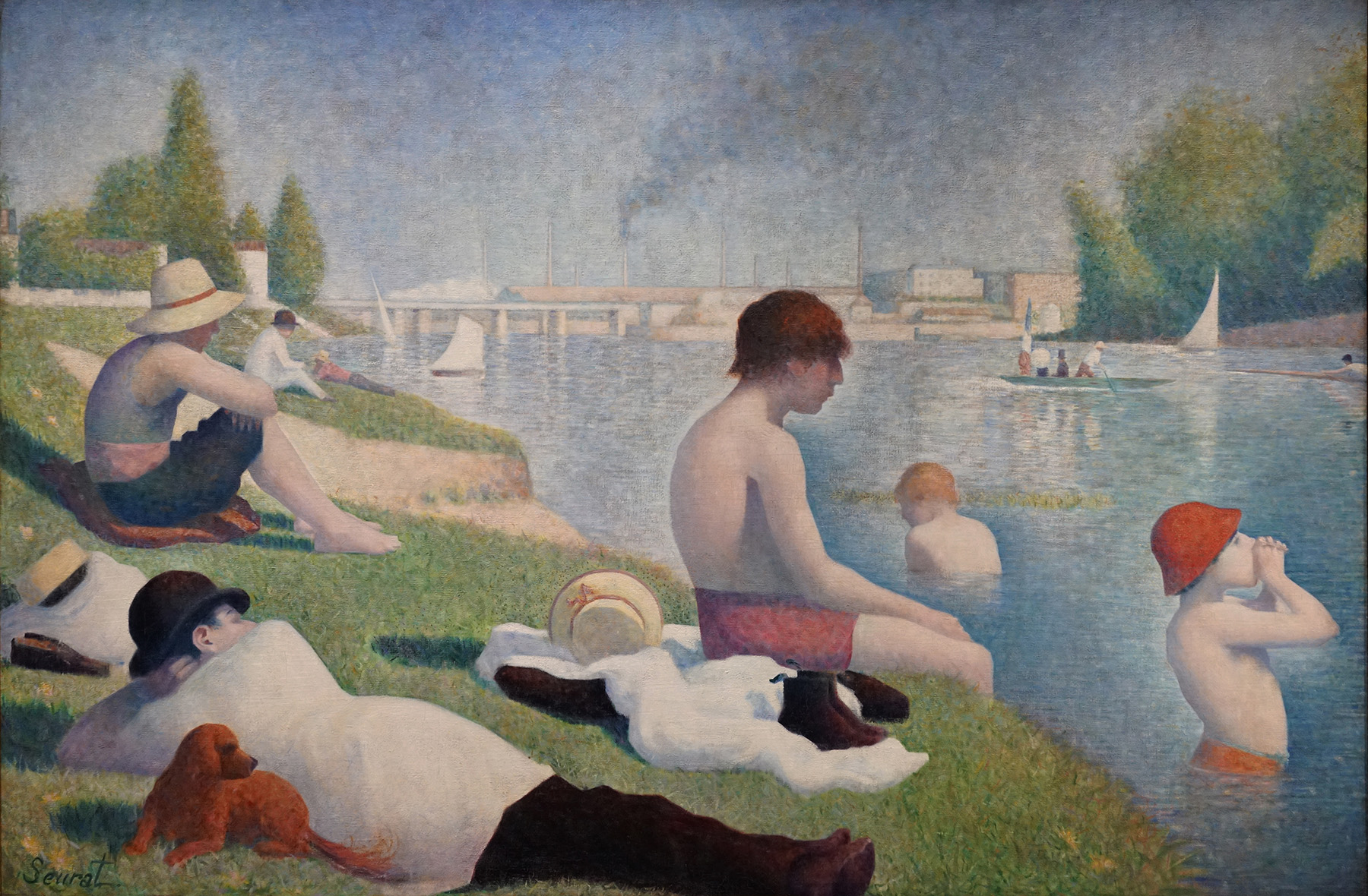 A painting depicting people relaxing and swimming by a riverside on a sunny day, showcasing leisure activities and calm water with boats in the background. The scene features individuals in various poses, including a man lying down with a dog, swimmers in the water, and others sitting on grassy banks, rendered in soft, pointillist brushstrokes with muted colors.