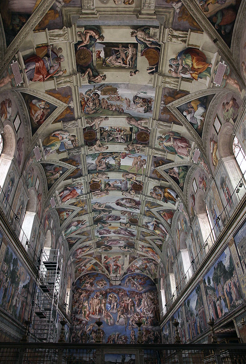 View of Michelangelo's Ceiling of the Sistine Chapel featuring a vaulted ceiling covered with intricate Renaissance frescoes depicting biblical scenes and figures. Walls display additional detailed paintings, with scaffolding visible on one side indicating ongoing restoration or maintenance work.