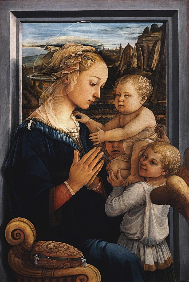 A Renaissance-style painting depicting a woman in a dark blue dress with a white veil holding a baby, accompanied by a young child with wings, likely representing an angel. The background features rocky cliffs and a cloudy sky, with intricate details in clothing textures and a small ornate box in the foreground.