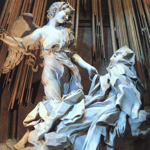 St. Teresa in ecstasy with an angel looming over her holding a golden spear.